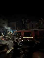 Crowd gathers around damaged vehicle in Gaza City