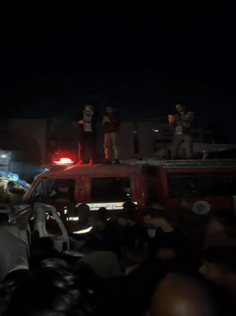 Crowd gathers around damaged vehicle in Gaza City