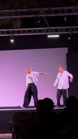 Outdoor stage performance with dancers draws audience in Italian coastal town