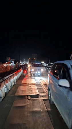 Nighttime traffic crosses temporary bridges in Aceh, Indonesia