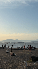 Vancouver beachgoers enjoy volleyball and socializing during golden hour