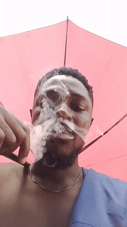 Man with umbrella spotted on Abuja street