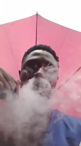 Man with umbrella spotted on Abuja street