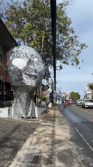 Reflective human head sculpture spotted in Kuta Selatan street