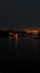 Berlin waterfront glows at dusk, skyline reflected on calm water