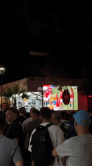 Nesebar beach crowd watches live soccer on outdoor screen