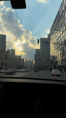 Vehicle navigates Moscow streets under partly cloudy skies