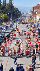Street parade proceeds through Cuzco, Peru