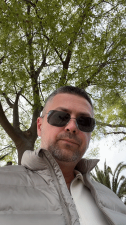 Woman enjoys beverage outside Ice Baby shop in Budva