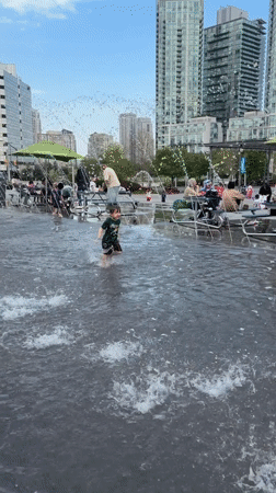Child plays in water jets at Mississauga fountain