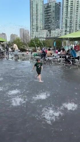 Child plays in water jets at Mississauga fountain