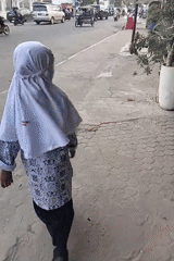 Students gather outdoors near Lhokseumawe's city center landmarks