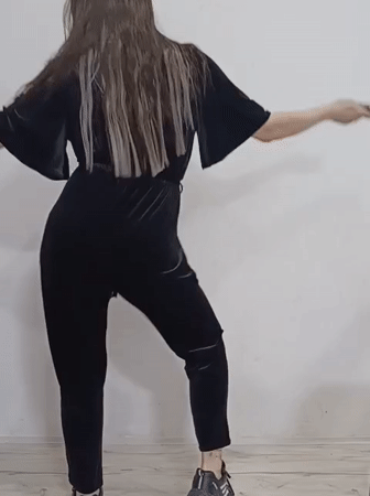 Woman dances, poses with roses in Rusalevka home