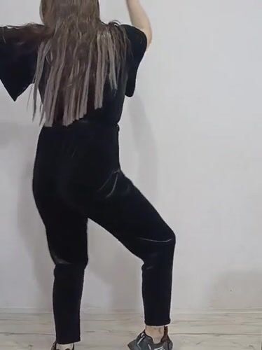 Woman dances, poses with roses in Rusalevka home