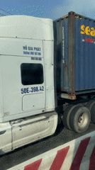 Semi-truck, motorcycles share busy Vietnam street in Trảng Bàng