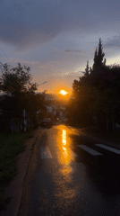 Sunset reflects off wet hillside road in Đà Lạt