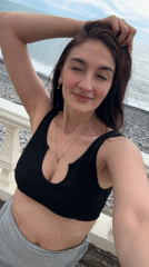 Woman takes seaside selfie from Sochi balcony
