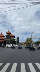 Motorcycle traffic observed at Denpasar intersection early morning