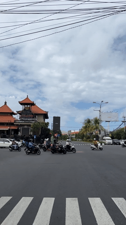 Motorcycle traffic observed at Denpasar intersection early morning