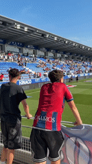 Soccer team warms up before match in Huesca stadium