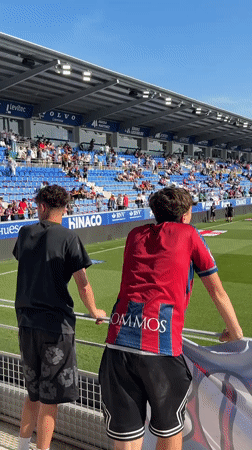 Soccer team warms up before match in Huesca stadium