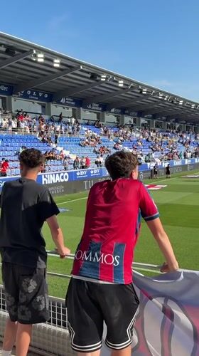 Soccer team warms up before match in Huesca stadium