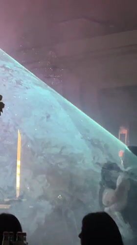 Indoor celebration with dramatic lighting and dancing in Vayk