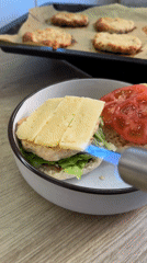 Person prepares torch-melted cheese sandwich in Krasnoyarsk kitchen