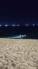 Night scenes on Nha Trang beach with city lights behind