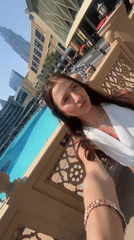 Tourists photograph Dubai skyline and Burj Khalifa during morning visit
