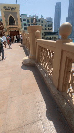 Tourists photograph Dubai skyline and Burj Khalifa during morning visit