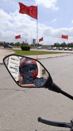 Motorcyclist uses phone while riding in Meknes, Morocco