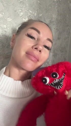 Woman holds distinctive red stuffed toy in Abakan