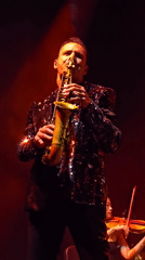 Late-night musical performance features singer and instrumentalists in Los Angeles