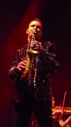 Late-night musical performance features singer and instrumentalists in Los Angeles