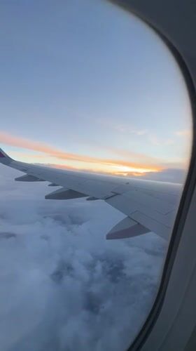 Passenger captures sunset view from airplane wing above Bulgarian clouds