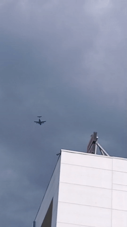 Woman displays race bib in Riga amid aircraft sighting