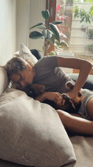 Woman spends morning playing with dog on couch in Thailand