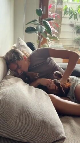 Woman spends morning playing with dog on couch in Thailand