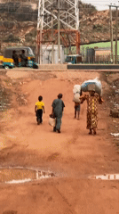 Children walk dirt roads after rain in Gura Top Nigeria