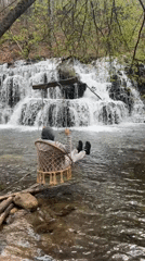Visitors document scenic waterfall and forest in Bulgarian countryside