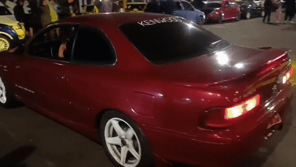 Car meet and street dancing around Arica sign