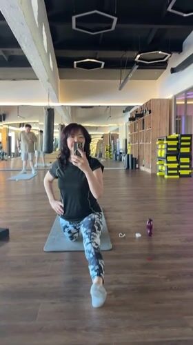 Woman takes selfie while stretching at Kokshetau gym