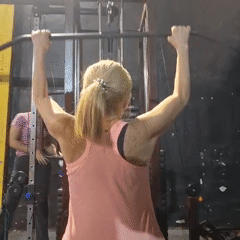 Woman performs lat pulldowns at gym in Wilde, Argentina