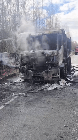 Burnt truck smoking on roadside in Zavod Mikhailovskii, Russia