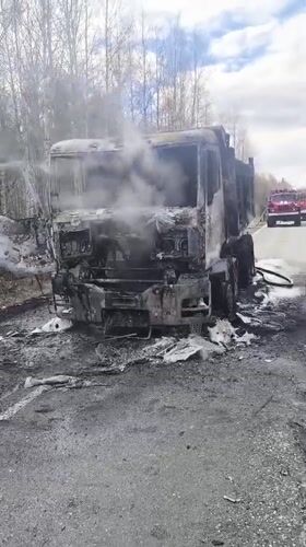Burnt truck smoking on roadside in Zavod Mikhailovskii, Russia