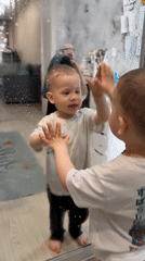 Toddlers engage in household activities in Rusanovo home