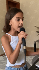 Indoor vocal performance at a mic in Gulkevichi, Russia