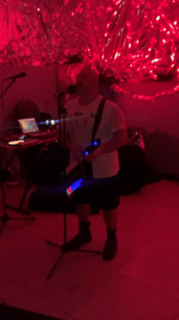 Musical performance with keytar in red-lit Buenos Aires room