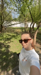Woman takes selfies in Khimki park wearing noodle shop shirt